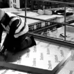 Building professional installing xtratherm insulation boards on roof