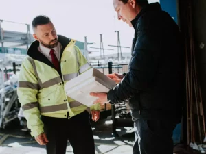 two male employees looking at products for merchant